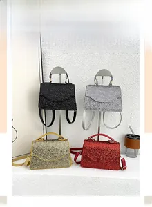 Four evening clutch bags in black, silver, gold and red with sparkling glitter finish