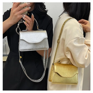 Detailed view of luxury gold and silver evening bags with metallic cracked PU texture