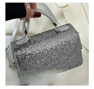 Close-up of sparkling silver rhinestone handbag with elegant metal clasp and top handle