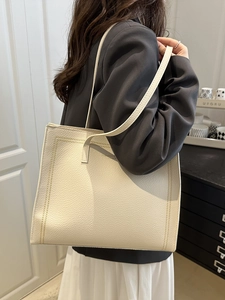 Retro large cream tote bag in lychee leather with yellow stitching detail shown on model