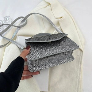 Close-up of sparkling silver sequin evening bag with elegant chain strap for parties