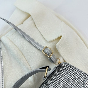Detail of silver rhinestone mesh bag with gray leather strap and gold hardware
