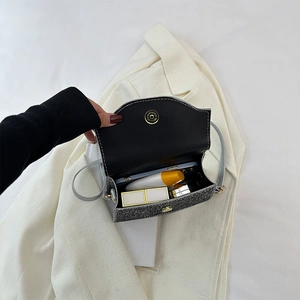 Interior view of mini evening bag showing capacity for phone, lipstick and cosmetics