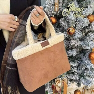 Brown faux suede tote bag with white faux fur trim shown in a festive holiday setting