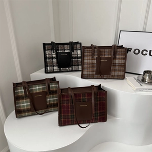 Detail view of plaid tote bags in various colors with leather pocket and shoulder straps
