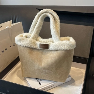 Plush faux shearling bucket bag in camel and white, autumn winter tote on a soft background