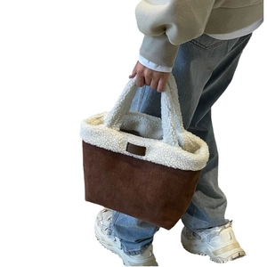 Brown faux suede tote bag with white faux shearling trim and plush top handles