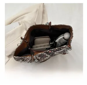 Internal view of ethnic canvas tote showing spacious main compartment and brown leather handles
