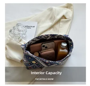 Internal view of large capacity ethnic woven bag showing items and magnetic clasp