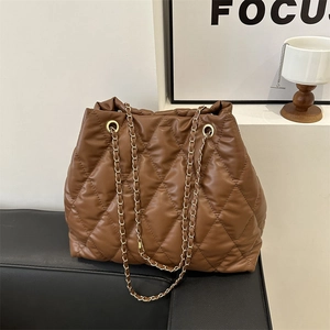 Deep brown quilted bucket bag with gold chain strap and elegant diamond lattice texture