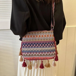 Bohemian ethnic style woven crossbody bucket bag with colorful tassels and wide strap