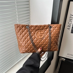 Large brown quilted leather tote bag with chain straps and circular logo design