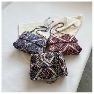 Detailed close-up of woven chain crossbody bags in blue and red ethnic geometric patterns