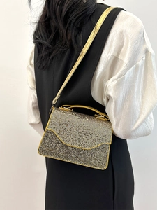 Elegant gold sequin mini handbag with chain strap shown on a model for evening parties
