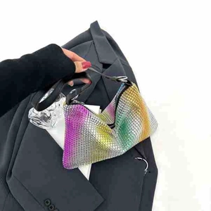 Detailed close-up of rainbow gradient rhinestones and metallic rings on the handbag