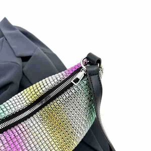 Detail of colorful gradient rhinestones transition on stylish shoulder handbag