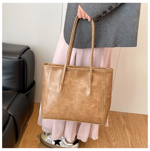 Vista dettagliata di una borsa tote vintage in pelle marrone con trama marmorizzata