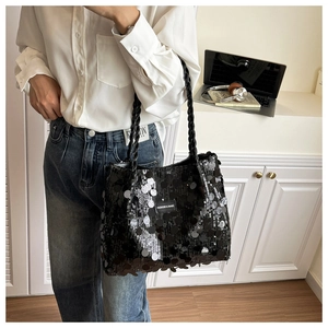 Detail of black sequin tote bag showing sparkling circular sequins and rope handles