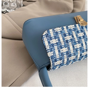 Detail of blue leather and tweed patchwork on high-quality shoulder bag with golden lock