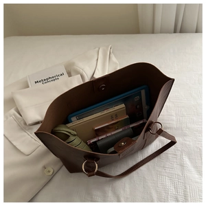 Top view showing spacious interior of large brown tote bag with various accessories