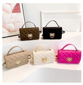 Group of colorful quilted leather crossbody bags with heart buckles on white display