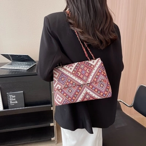 Ethnic style woven crossbody bag with geometric patterns and golden chain strap for women