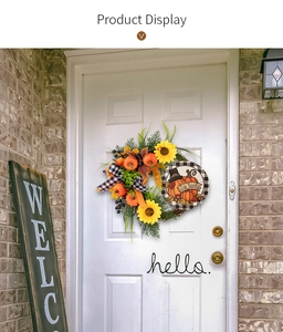 Detail of Give Thanks pumpkin wreath with sunflowers and berries on a white front door