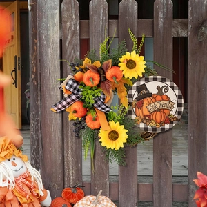 Detail of harvest wreath with pumpkins and sunflowers plus Give Thanks wooden sign