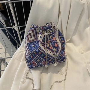 Ethnic geometric canvas bucket bag with silver chain strap and pearl drawstring detail