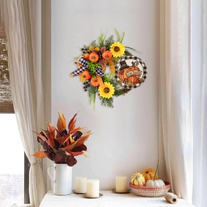Detail of harvest wreath featuring sunflowers, pumpkins, and a Give Thanks sign
