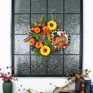 Detail of Give Thanks pumpkin wreath with sunflowers, maple leaves and a buffalo plaid bow