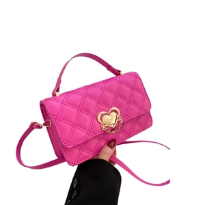 Hot pink quilted crossbody bag with golden heart lock and adjustable shoulder strap