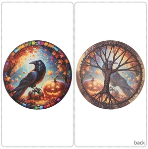 Detail of stained glass Halloween raven and pumpkin decoration showing front and back view