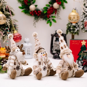 Three plush Christmas figurines of Santa, snowman and reindeer on a festive background