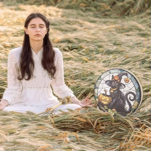 Outdoor setting of a Halloween drum with a witch cat and pumpkin stained glass pattern