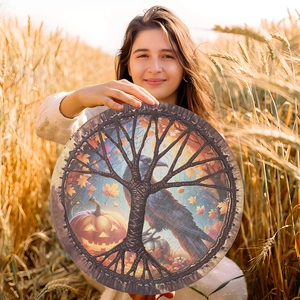 Macro detail of Halloween percussion drum with crow and pumpkin motifs in a wheat field