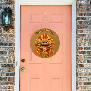 Detail of wooden Thanksgiving turkey door sign hanging on a peach wood door
