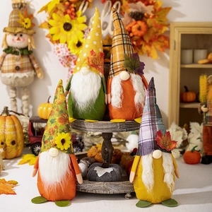 Close-up of autumn gnomes with maple leaves and sunflowers on a rustic tiered wooden tray