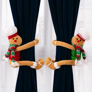 Pair of knitted gingerbread man curtain tiebacks with chef hats for Christmas decor