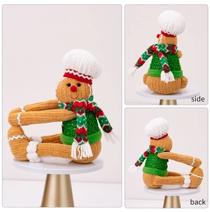 Detailed front, side and back views of a knitted gingerbread man curtain buckle decoration