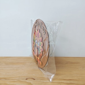 Detail of wooden Thanksgiving turkey door sign with natural jute rope in packaging