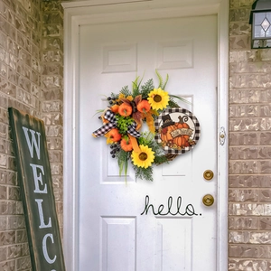 Thanksgiving pumpkin and sunflower wreath with Give Thanks sign for front door decor