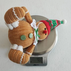 Detail of gingerbread plush doll made of corduroy fabric on a scale weighing 48.8g