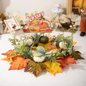 Detailed close-up of Thanksgiving wreath with colorful maple leaves and mini pumpkins