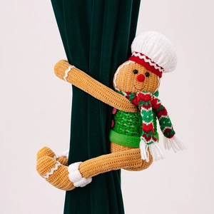 Detail of gingerbread man curtain tieback with chef hat on green velvet drape