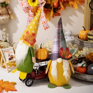 Detail of fall harvest gnomes with maple leaf hats on a decorative tiered tray display