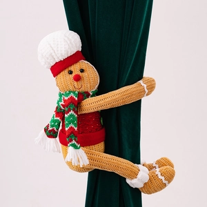 Detail of gingerbread man curtain tieback with chef hat and scarf on velvet fabric