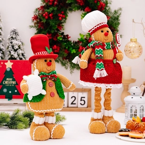 Set of two decorative Christmas gingerbread man plush dolls in a festive winter scene