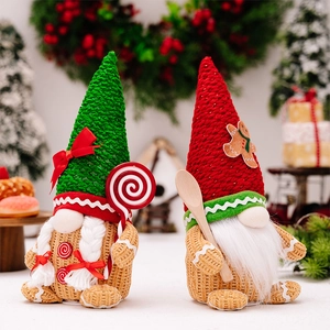 Detail of Christmas gingerbread gnomes with knit hats and candy cane decorations
