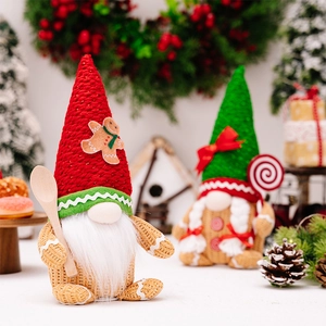 Close-up of festive Christmas gnomes with gingerbread motifs and warm LED lighting